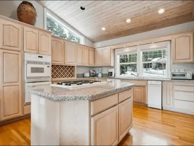 a kitchen with white appliances and wooden cabinets at The Royal Canterbury Retreat - Near Kings Beach & Lake Tahoe in Kings Beach