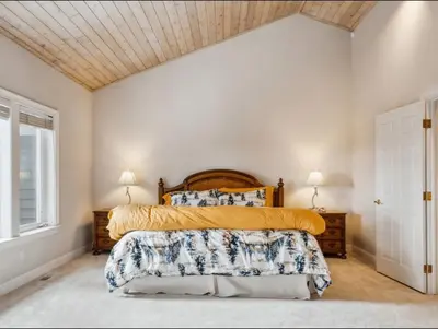 a bedroom with a large bed with a wooden headboard at The Royal Canterbury Retreat - Near Kings Beach & Lake Tahoe in Kings Beach