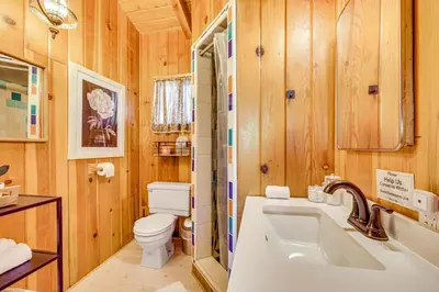 a bathroom with a tub and a toilet and a sink at Peaceful Wooden Cabin, 2 Mi to Bass Lake! in Oakhurst
