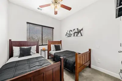 a bedroom with two beds and a ceiling fan at Cozy 2bdr, 1br home near downtown in Sacramento