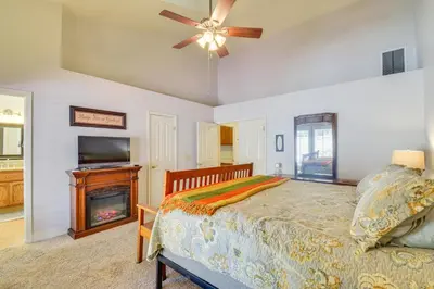 a bedroom with a bed and a fireplace at 1 Mi to Applegate Park Zoo Pet-Friendly Home in Merced