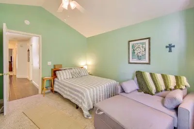 a living room with a couch and a bed at 1 Mi to Applegate Park Zoo Pet-Friendly Home in Merced