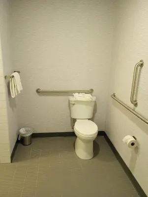 a bathroom with a white toilet in a restroom at My TRI Suites Reno Sparks in Clark