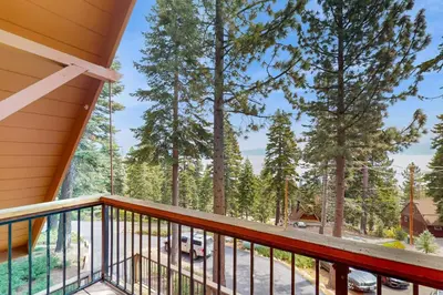 a balcony with a view of the woods at Lakeview Cabin in Tahoma