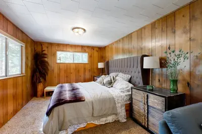 a bedroom with a bed in a wooden wall at 3 Mi to State Park Quiet Escape with Deck in Arnold in Dorrington