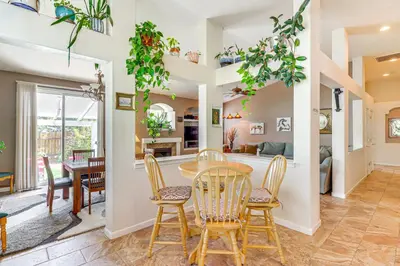 a dining room and living room with a table and chairs at Game Room and Fireplace Reno Home 5 Mi to Dtwn! in Reno