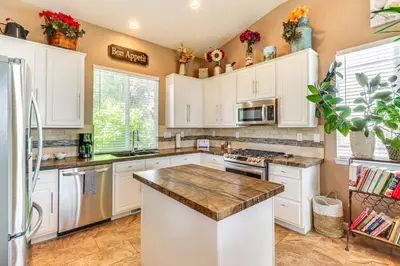 a kitchen with white cabinets and a counter top at Game Room and Fireplace Reno Home 5 Mi to Dtwn! in Reno