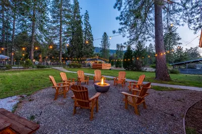 a group of chairs and a table with a candle at Pool-GameRoom-HomeTheater-Bar-PlayStructure-FirePit in Oakhurst