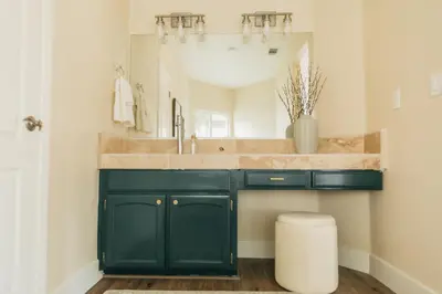 a bathroom with a green vanity with a large mirror at Panoramic Lookout Sierra Serenity BBQ by CasaOso in Mariposa