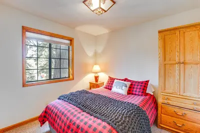 a bedroom with a bed and a window at Deck with Mountain Views Cabin in Bear Valley! in Bear Valley