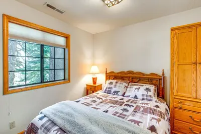 a bedroom with a bed and a window at Deck with Mountain Views Cabin in Bear Valley! in Bear Valley