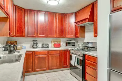 a kitchen with wooden cabinets and a stove top oven at Forest-View Haven with Game Room Tahoe City Gem! in Tahoe City