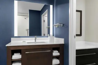 a bathroom with a sink and a mirror at Residence Inn by Marriott Sacramento Cal Expo in Sacramento