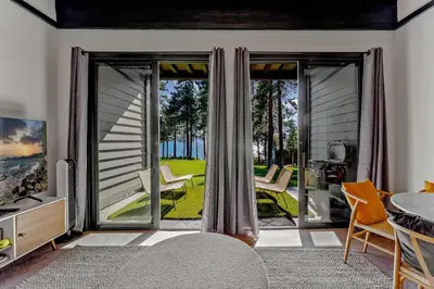 a living room with a large sliding glass door at Lake Tahoe Vacation Rental w Patio & Pool Access in Kings Beach