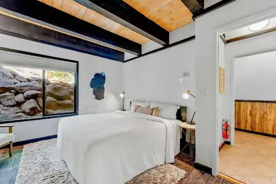 a bedroom with a large white bed and a window at Lake Tahoe Vacation Rental w Patio & Pool Access in Kings Beach