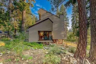 a small house in the woods with a gambrel roof at Carnelian Bay 3BR + Loft Near Beach & Trails in Carnelian Bay
