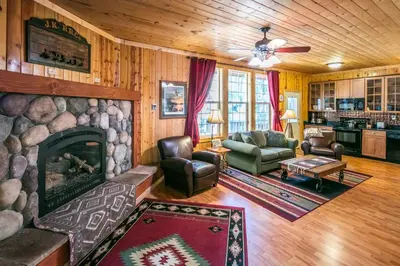 a living room with a fireplace in a house at Cabin minutes from Yosemite in Fish Camp