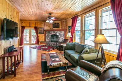 a living room with a couch and a fireplace at Cabin minutes from Yosemite in Fish Camp