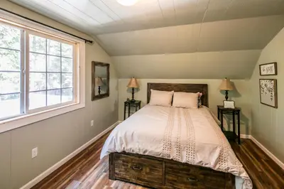 a bedroom with a bed and a window at Cabin minutes from Yosemite in Fish Camp