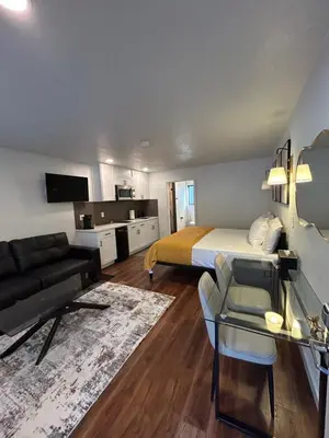 a hotel room with a bed and a couch at Mi Wuk Village Inn in Mi-Wuk Village