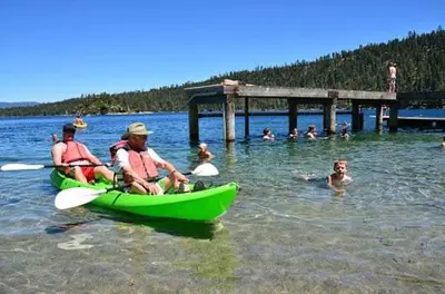 a group of people in a green kayak in the water at Luxe 4 lake Tahoe Luxury With Hot Tub in Stateline