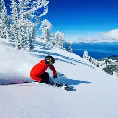 a person is skiing down a snow covered slope at Luxe 4 lake Tahoe Luxury With Hot Tub in Stateline