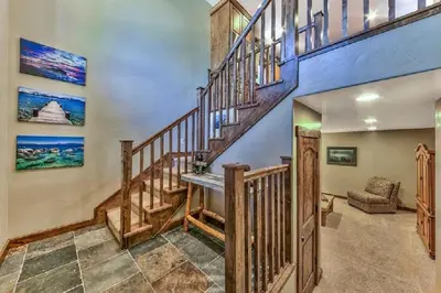 a wooden staircase in a home with blue walls at Lv12 luxury villa with hot tub, close to skiing in Glenbrook