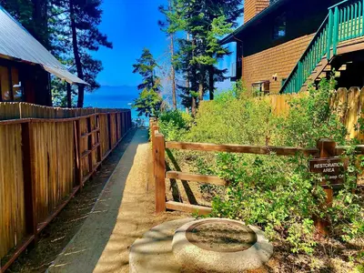 a wooden fence next to a house with a gate at Lv12 luxury villa with hot tub, close to skiing in Glenbrook