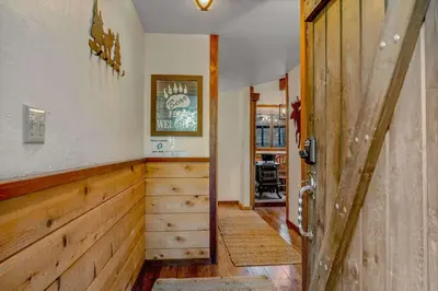 an open door to a room with wood paneling at Secluded Tahoe Retreat Near Trails and Beach in Carnelian Bay