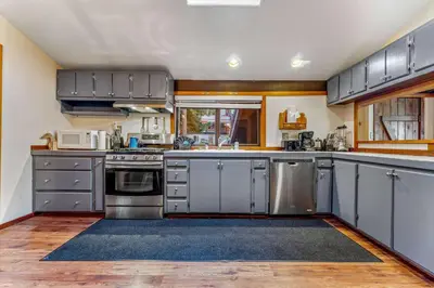 a large kitchen with stainless steel appliances and wood floors at Secluded Tahoe Retreat Near Trails and Beach in Carnelian Bay
