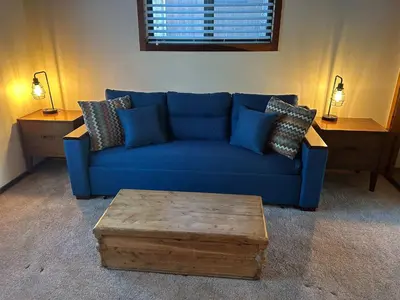 a blue couch with a coffee table in a living room at Secluded Tahoe Retreat Near Trails and Beach in Carnelian Bay