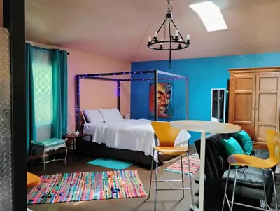 a bedroom with a bed and a table and chairs at Ping's Tiny Home self-check in & out private in Merced