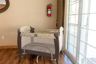 a hospital crib in a room next to a window at Manzanita Hill-35 miles to Yosemite, 10 miles to Mariposa with 8 person spa in Mariposa
