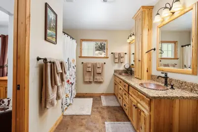 a bathroom with a sink and a mirror at Manzanita Hill-35 miles to Yosemite, 10 miles to Mariposa with 8 person spa in Mariposa