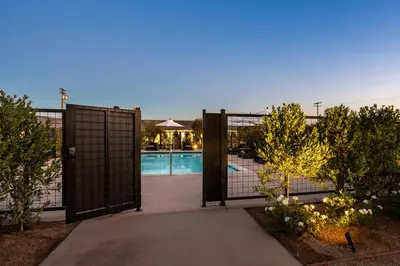 a gate leading to a swimming pool in a house at Hotel Bayit in Modesto