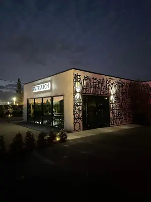a building with a sign on the side of it at night at Hotel Bayit in Modesto