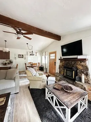 a living room with a couch and a fireplace at The Aspen House in Tahoma