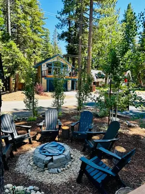a yard with chairs and a fire pit and a house at The Aspen House in Tahoma
