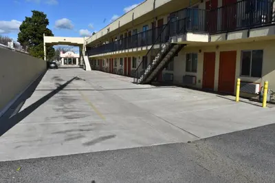 an empty parking lot in front of a building at Corcoran Inn in Corcoran