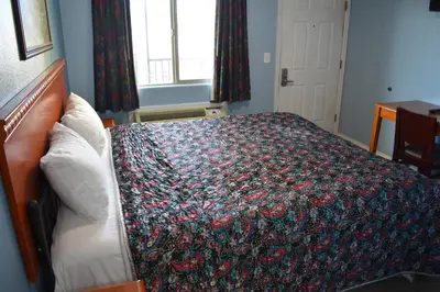 a bedroom with a bed with a colorful blanket on it at Corcoran Inn in Corcoran