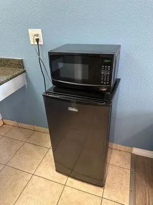 a microwave sitting on top of a refrigerator at Corcoran Inn in Corcoran