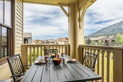 a wooden table on the balcony of a house at Lodges 1156 in Mammoth Lakes