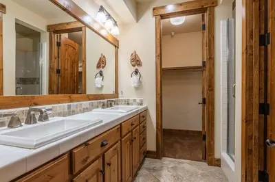 a bathroom with two sinks and a mirror at Lodges 1156 in Mammoth Lakes
