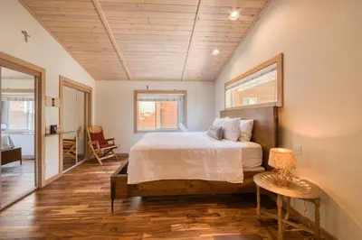 a bedroom with a bed and a table with a lamp at Landfall on the North Shore - Fenced Yard, Walking Distance to Lake in Kings Beach
