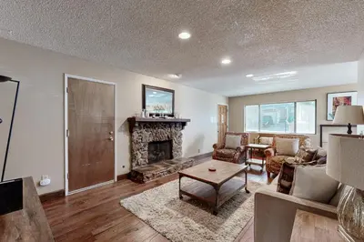a living room with a fireplace and a table at Incline Haven in Incline Village