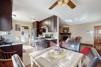 a kitchen and living room with a table and a ceiling fan at Incline Haven in Incline Village