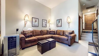 a living room with a couch and a television at Woodwinds #1303 condo in Mammoth Lakes