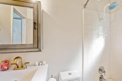 a bathroom with a sink and a mirror and a shower at Snowy Pines in Fish Camp