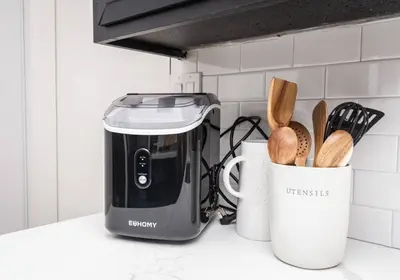 a kitchen counter with a toaster and a cup of utensils at Main Street Retreat in Roseville
