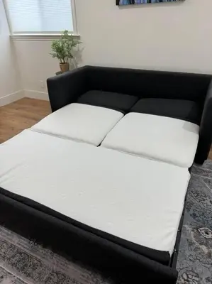 a black and white bed in a room at Main Street Retreat in Roseville